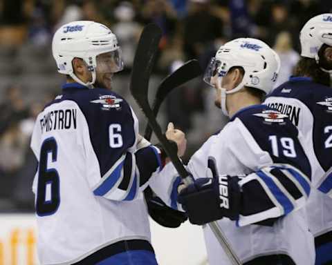 Nov 4, 2015; Toronto, Ontario, CAN; Winnipeg Jets forward Alexander Burmistrov (6) and Winnipeg Jets forward Nic Petan (19) celebrate a win over the Toronto Maple Leafs at Air Canada Centre. Winnipeg defeated Toronto 4-2. Mandatory Credit: John E. Sokolowski-USA TODAY Sports