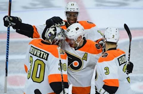 Nov 2, 2016; Philadelphia, PA, USA; Philadelphia Flyers goalie Michal Neuvirth (30) celebrates win with defenseman Mark Streit (32), right wing Wayne Simmonds (17) and defenseman Radko Gudas (3) against Detroit Red Wings at Wells Fargo Center. The Flyers defeated the Red Wings, 4-3 in overtime. Mandatory Credit: Eric Hartline-USA TODAY Sports