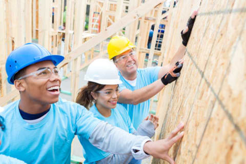 Volunteers help build a house