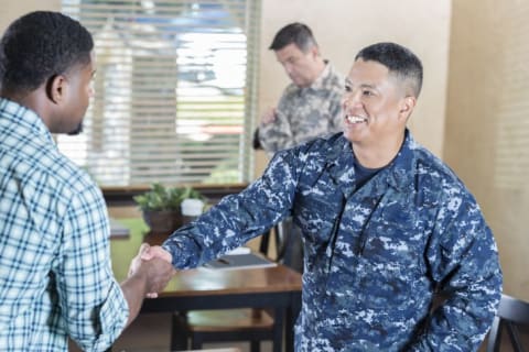 military men meeting in an office setting