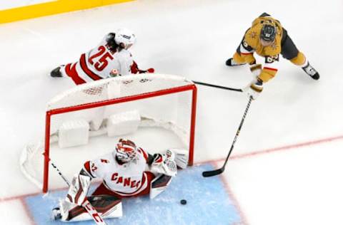 LAS VEGAS, NEVADA – NOVEMBER 16: Antti Raanta #32 of the Carolina Hurricanes makes a save against Evgenii Dadonov #63 of the Vegas Golden Knights as Ethan Bear #25 of the Hurricanes defends in the first period of their game at T-Mobile Arena on November 16, 2021, in Las Vegas, Nevada. The Hurricanes defeated the Golden Knights 4-2. (Photo by Ethan Miller/Getty Images)