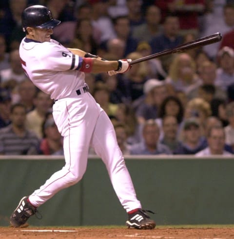 BOSTON, UNITED STATES: Boston Red shortstop Nomar Garciaparra drives in a run on a double in the third inning against the Anaheim Angels at Fenway Park 23 August 2002. AFP PHOTO/JOHN MOTTERN (Photo credit should read JOHN MOTTERN/AFP/Getty Images)