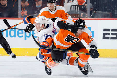 PHILADELPHIA, PENNSYLVANIA – JANUARY 18: Anthony Beauvillier #18 of the New York Islanders and Rasmus Ristolainen #70 of the Philadelphia Flyers collide during the second period at Wells Fargo Center on January 18, 2022 in Philadelphia, Pennsylvania. (Photo by Tim Nwachukwu/Getty Images)