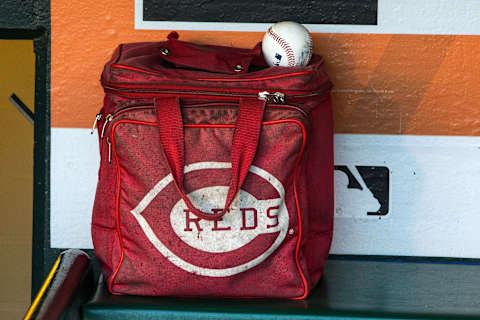 SAN FRANCISCO, CA – JULY 26: Detailed view of a baseball bag and a baseball in the Cincinnati Reds dugout before the game against the San Francisco Giants at AT