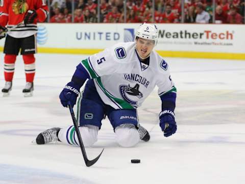 Apr 2, 2015; Chicago, IL, USA; Vancouver Canucks defenseman Luca Sbisa (5) after having his lip cut by a high stick from Chicago Blackhawks center Antoine Vermette (not pictured) during the first period at the United Center. Mandatory Credit: Dennis Wierzbicki-USA TODAY Sports