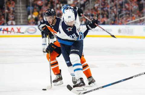 EDMONTON, AB – OCTOBER 09: Connor McDavid #97 of the Edmonton Oilers gets the puck away from Patrik Laine #29 of the Winnipeg Jets at Rogers Place on October 9, 2017 in Edmonton, Canada. (Photo by Codie McLachlan/Getty Images)