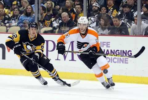 Jan 21, 2016; Pittsburgh, PA, USA; Pittsburgh Penguins left wing Carl Hagelin (62) and Philadelphia Flyers defenseman Shayne Gostisbehere (53) chase the puck during the first period at the CONSOL Energy Center. Mandatory Credit: Charles LeClaire-USA TODAY Sports