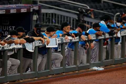 The Miami Marlins stand in the dugout during (Photo by Kevin C. Cox/Getty Images)