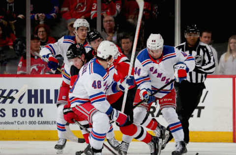 NEWARK, NJ – APRIL 01: Pavel Zacha #37 of the New Jersey Devils and Neal Pionk #44 and Brendan Lemieux #48 of the New York Rangers battle for a loose puck during the game at Prudential Center on April 1, 2019 in Newark, New Jersey. (Photo by Andy Marlin/NHLI via Getty Images)