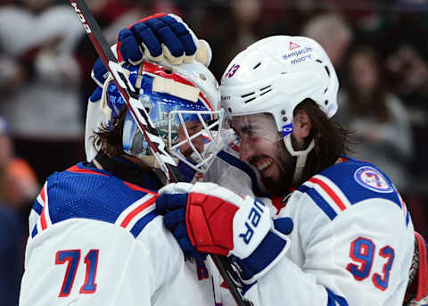 Dec 15, 2021; Glendale, Arizona, USA; New York Rangers goaltender Keith Kinkaid (71) and center Mika Zibanejad (93) celebrate after defeating the Arizona Coyotes at Gila River Arena. Mandatory Credit: Joe Camporeale-USA TODAY Sports