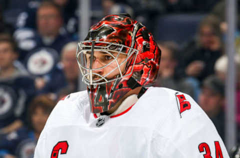 WINNIPEG, MB – DECEMBER 17: Goaltender Petr Mrazek #34 of the Carolina Hurricanes looks on during third period action against the Winnipeg Jets at the Bell MTS Place on December 17, 2019 in Winnipeg, Manitoba, Canada. The Canes defeated the Jets 6-3. (Photo by Jonathan Kozub/NHLI via Getty Images)