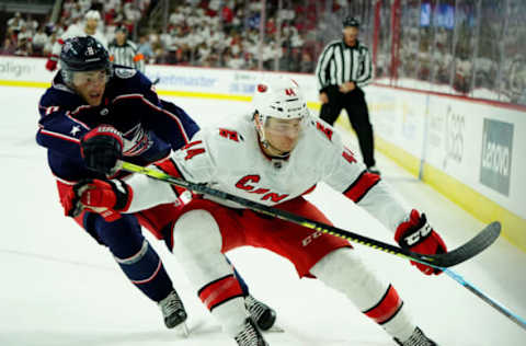 RALEIGH, NC – OCTOBER 12: Julien Gauthier #44 of the Carolina Hurricanes and Zach Werenski of the Columbus Blue Jackets battle along the boards during an NHL game on October 12, 2019 at PNC Arena in Raleigh North Carolina. (Photo by Gregg Forwerck/NHLI via Getty Images)