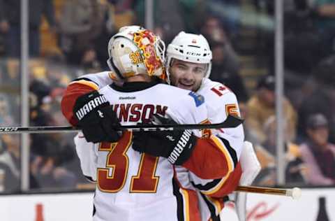 Nov 25, 2016; Boston, MA, USA; Calgary Flames goalie Chad Johnson (31) celebrates with defenseman Mark Giordano (5) after defeating the Boston Bruins at TD Garden. Mandatory Credit: Bob DeChiara-USA TODAY Sports