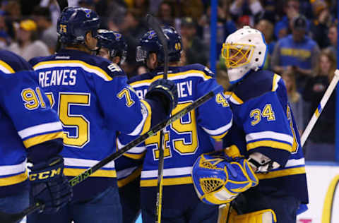 Feb 16, 2017; St. Louis, MO, USA; St. Louis Blues goalie Jake Allen (34) is congratulated by teammates after the Blues defeat the Vancouver Canucks 4-3 at Scottrade Center. Mandatory Credit: Billy Hurst-USA TODAY Sports