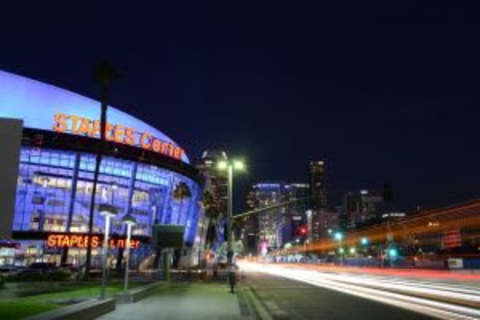 Dec 1, 2015; Los Angeles, CA, USA; General view of the Staples Center exterior on Figueroa St. and downtown Los Angeles skyline before an NHL match between the Vancouver Canucks and the Los Angeles Kings. Mandatory Credit: Kirby Lee-USA TODAY Sports