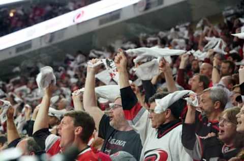 RALEIGH, NC – MAY 14: Fans of the Carolina Hurricanes celebrate in Game Three of the Eastern Conference Third Round against the Boston Bruins during the 2019 NHL Stanley Cup Playoffs on May 14, 2019 at PNC Arena in Raleigh, North Carolina. (Photo by Gregg Forwerck/NHLI via Getty Images)