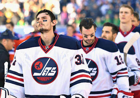 WINNIPEG, MB – OCTOBER 23: Goaltender Connor Hellebuyck #37 of the Winnipeg Jets lines up to take the ice before playing in the 2016 Tim Hortons NHL Heritage Classic against the Edmonton Oilers at Investors Group Field on October 23, 2016 in Winnipeg, Canada. (Photo by Andy Devlin/NHLI via Getty Images)