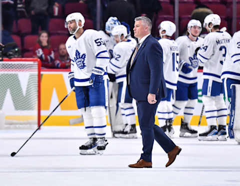 Head coach of the Toronto Maple Leafs, Sheldon Keefe, walks across the ice after (Photo by Minas Panagiotakis/Getty Images)