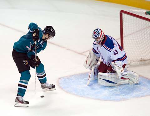 Oct 8, 2013; San Jose, CA, USA; San Jose Sharks center Tomas Hertl (48) shoots the puck between his legs past New York Rangers goalie Martin Biron (43) during the third period at SAP Center at San Jose. The San Jose Sharks defeated the New York Rangers 9-2. Mandatory Credit: Ed Szczepanski-USA TODAY Sports