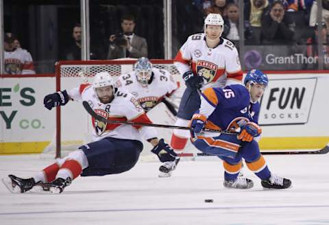 NEW YORK, NEW YORK – OCTOBER 24: Aaron Ekblad #5 of the Florida Panthers and Cal Clutterbuck #15 of the New York Islanders pursue the puck during the third period at the Barclays Center on October 24, 2018 in the Brooklyn borough of New York City. (Photo by Bruce Bennett/Getty Images)