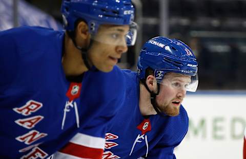 K’Andre Miller and Alexis Lafreniere wait for a faceoff in their first NHL game together. (Photo by Bruce Bennett/Getty Images)