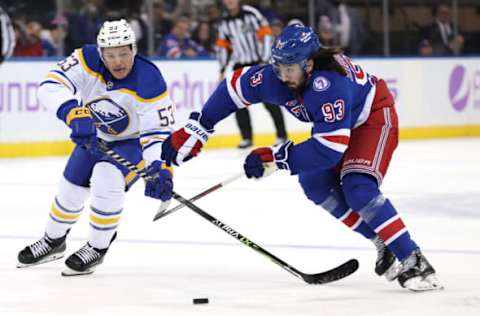 NEW YORK, NEW YORK – NOVEMBER 21: Jeff Skinner #53 of the Buffalo Sabres and Mika Zibanejad #93 of the New York Rangers go after the puck in the first period at Madison Square Garden on November 21, 2021, in New York City. (Photo by Elsa/Getty Images)