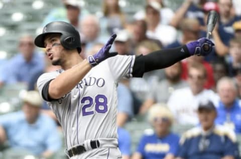 Aug 24, 2016; Milwaukee, WI, USA; Colorado Rockies third baseman Nolan Arenado (28) hits a solo home run in the first inning during the game against the Milwaukee Brewers at Miller Park. Mandatory Credit: Benny Sieu-USA TODAY Sports