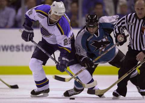 21 Apr 2000: Ron Sutter #12 of the San Jose Sharks and Lubos Bartecko #23 of the St. Louis Blues battle for the puck during the Stanley Cup Playoffs at the Kiel Center in St. Louis, Missouri. DIGITAL FILE. Mandatory Credit: Elsa/ALLSPORT