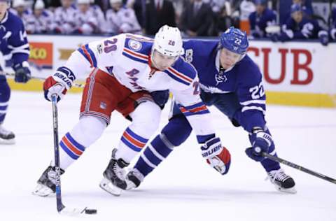 Feb 23, 2017; Toronto, Ontario, CAN; New York Rangers left wing Chris Kreider (20) carries the puck as Toronto Maple Leafs defenseman Nikita Zaitsev (22) defends at Air Canada Centre. Mandatory Credit: Tom Szczerbowski-USA TODAY Sports