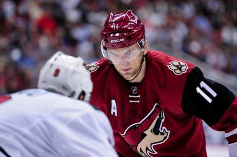 Oct 15, 2015; Glendale, AZ, USA; Arizona Coyotes center Martin Hanzal (11) stares down Minnesota Wild center Mikko Koivu (9) prior to a face off in the second period at Gila River Arena. Mandatory Credit: Matt Kartozian-USA TODAY Sports