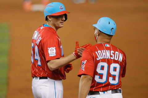 May 21, 2021; Miami, Florida, USA; Miami Marlins relief pitcher Ross Detwiler (54) shakes hands with first base coach Keith Johnson (99) after connecting for a base hit against the New York Mets in the third inning at loanDepot Park. Mandatory Credit: Sam Navarro-USA TODAY Sports