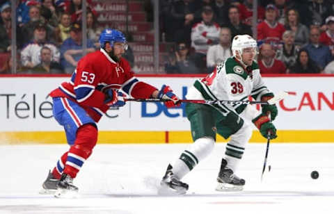 Mar 12, 2016; Montreal, Quebec, CAN; Minnesota Wild defenseman Nate Prosser (39) plays the puck against Montreal Canadiens left wing Lucas Lessio (53) during the first period at Bell Centre. Mandatory Credit: Jean-Yves Ahern-USA TODAY Sports