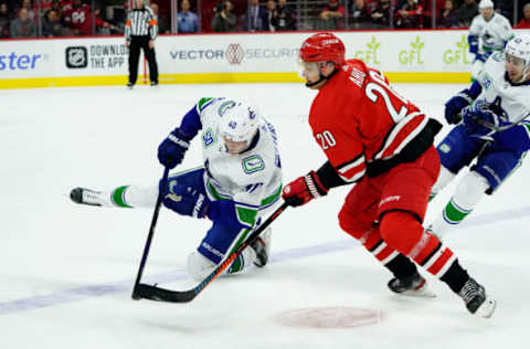 RALEIGH, NC – FEBRUARY 2: Sebastian Aho #20 of the Carolina Hurricanes and Quinn Hughes #43 of the Vancouver Canucks battle during an NHL game on February 2, 2020 at PNC Arena in Raleigh, North Carolina. (Photo by Gregg Forwerck/NHLI via Getty Images)