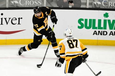 Jan 26, 2021; Boston, Massachusetts, USA; Boston Bruins center Patrice Bergeron (37) attempts a shot past Pittsburgh Penguins center Sidney Crosby (87) during the first period at the TD Garden. Mandatory Credit: Brian Fluharty-USA TODAY Sports