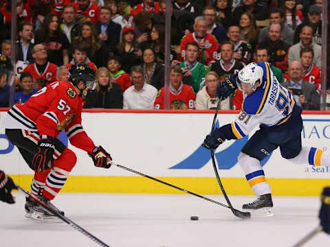 Apr 7, 2016; Chicago, IL, USA; St. Louis Blues right wing Vladimir Tarasenko (91) shoots the puck as Chicago Blackhawks defenseman Trevor van Riemsdyk (57) defends during the second period at the United Center. Mandatory Credit: Dennis Wierzbicki-USA TODAY Sports