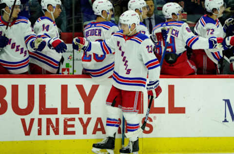 RALEIGH, NC – NOVEMBER 7: Adam Fox #23 of the New York Rangers scores an empty net goal and celebrates with teammates sealing a victory over the Carolina Hurricanes during an NHL game on November 7, 2019 at PNC Arena in Raleigh, North Carolina. (Photo by Gregg Forwerck/NHLI via Getty Images)