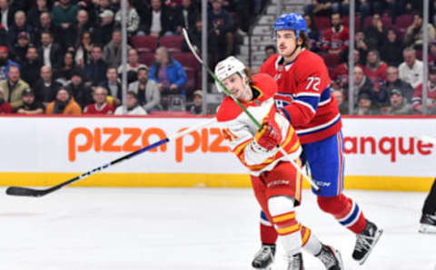 MONTREAL, CANADA - DECEMBER 12: Arber Xhekaj #72 of the Montreal Canadiens holds back Matthew Phillips #41 of the Calgary Flames during the first period at Centre Bell on December 12, 2022 in Montreal, Quebec, Canada. (Photo by Minas Panagiotakis/Getty Images)