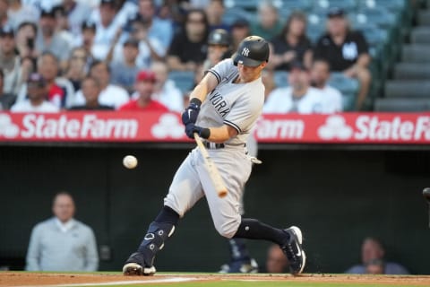 Aug 30, 2022; Anaheim, California, USA; New York Yankees left fielder Andrew Benintendi (18) follows through on a solo home run in the first inning against the Los Angeles Angels at Angel Stadium. Mandatory Credit: Kirby Lee-USA TODAY Sports