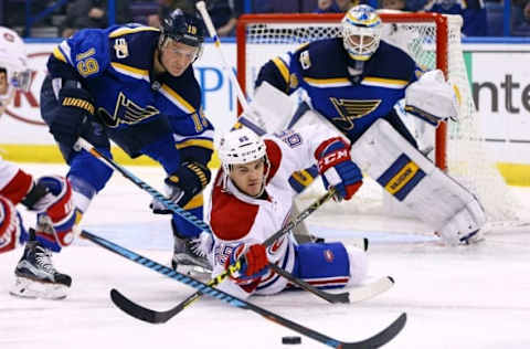 NHL Power Rankings: Montreal Canadiens center Andrew Shaw (65) reaches for the puck as he falls to the ice and is pressured by St. Louis Blues defenseman Jay Bouwmeester (19) during the third period at Scottrade Center. The Blues won 3-2 in overtime. Mandatory Credit: Billy Hurst-USA TODAY Sports