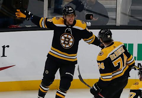 BOSTON – OCTOBER 14: Boston Bruins’ David Pastrnak (88, left) celebrates his goal against the Anaheim Ducks with Bruins teammate Jake DeBrusk (74) during the first period. The Boston Bruins host the Anaheim Ducks in a regular season NHL hockey game at TD Garden on Oct. 14, 2019. (Photo by Jessica Rinaldi/The Boston Globe via Getty Images)