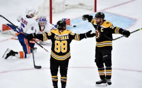 May 29, 2021; Boston, MA, USA; Boston Bruins right wing David Pastrnak (88) reacts with center Patrice Bergeron (37) after scoring his second goal of the game during the second period in game one of the second round of the 2021 Stanley Cup Playoffs against the New York Islanders at TD Garden. Mandatory Credit: Bob DeChiara-USA TODAY Sports