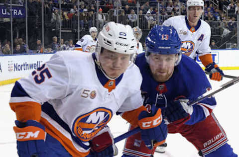 NEW YORK, NEW YORK – DECEMBER 22: Alexis Lafreniere #13 of the New York Rangers skates against Sebastian Aho #25 of the New York Islanders during the second period at Madison Square Garden on December 22, 2022, in New York City. (Photo by Bruce Bennett/Getty Images)