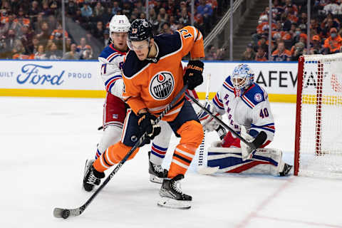 EDMONTON, AB – NOVEMBER 05: Jesse Puljujarvi #13 of the Edmonton Oilers battles against Nils Lundkvist #27 and goaltender Alexandar Georgiev #40 of the New York Rangers during the second period at Rogers Place on November 5, 2021 in Edmonton, Canada. (Photo by Codie McLachlan/Getty Images)