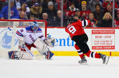 NEWARK, NJ – APRIL 03: New Jersey Devils left wing Taylor Hall (9) shoots and scores on a penalty shot against New York Rangers goaltender Henrik Lundqvist (30) during the second period of the National Hockey League Game between the New Jersey Devils and the New York Rangers on April 3, 2018, at the Prudential Center in Newark, NJ. (Photo by Rich Graessle/Icon Sportswire via Getty Images)