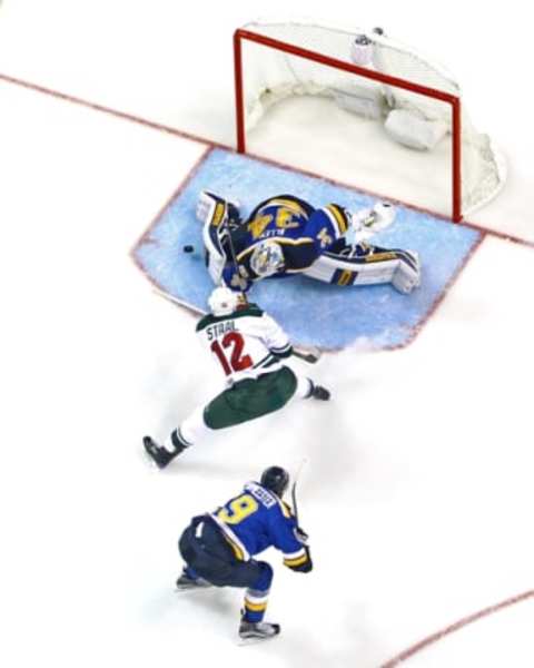 Oct 13, 2016; St. Louis, MO, USA; St. Louis Blues goalie Jake Allen (34) makes a save on a shot by Minnesota Wild center Eric Staal (12) as he is pressured by Blues