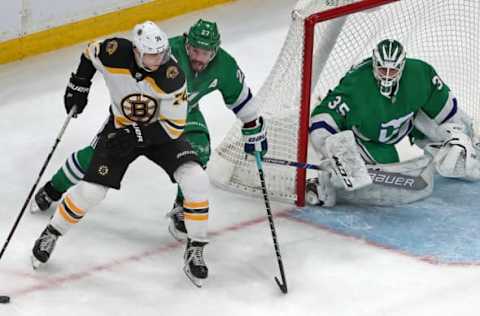 BOSTON – MARCH 5: Boston Bruins’ Jake DeBrusk (74), after taking the puck away from the Hurricanes Justin Faulk (27), eyes teammate David Krejci (not pictured) heading to the net. DeBrusk hit him with a pass and Krejci beat Hurricanes goalie Curtis McElhinney (35) in overtime to give Boston a 4-3 victory. The Boston Bruins host the Carolina Hurricanes in a regular season NHL hockey game at TD Garden in Boston on March 5, 2019. (Photo by Jim Davis/The Boston Globe via Getty Images)