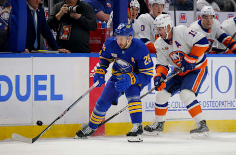 Jan 19, 2023; Buffalo, New York, USA; Buffalo Sabres left wing Zemgus Girgensons (28) and New York Islanders right wing Cal Clutterbuck (15) go after a loose puck during the first period at KeyBank Center. Mandatory Credit: Timothy T. Ludwig-USA TODAY Sports