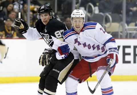 Jan 18, 2015; Pittsburgh, PA, USA; Pittsburgh Penguins center Sidney Crosby (87) and New York Rangers center Derek Stepan (21) battle for position during the third period at the CONSOL Energy Center. The Rangers won 5-2. Mandatory Credit: Charles LeClaire-USA TODAY Sports