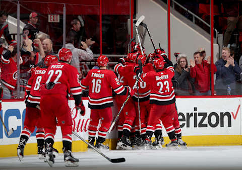 RALEIGH, NC – DECEMBER: Carolina Hurricanes players celebrate a game winning goal by Noah Hanifin #5 against the Florida Panthers during an NHL game on December 3, 2017 at PNC Arena in Raleigh, North Carolina. (Photo by Gregg Forwerck/NHLI via Getty Images)