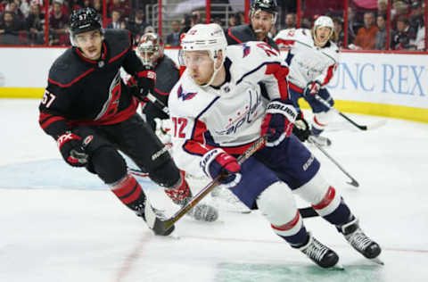 RALEIGH, NC – APRIL 18: Carolina Hurricanes defenseman Trevor van Riemsdyk (57) and Washington Capitals center Travis Boyd (72) chase after a puck during a game between the Carolina Hurricanes and the Washington Capitals on April 18, 2019, at the PNC Arena in Raleigh, NC. (Photo by Greg Thompson/Icon Sportswire via Getty Images)